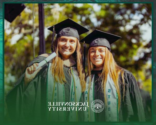 Students in graduation attire holding diplomas during a graduation ceremony